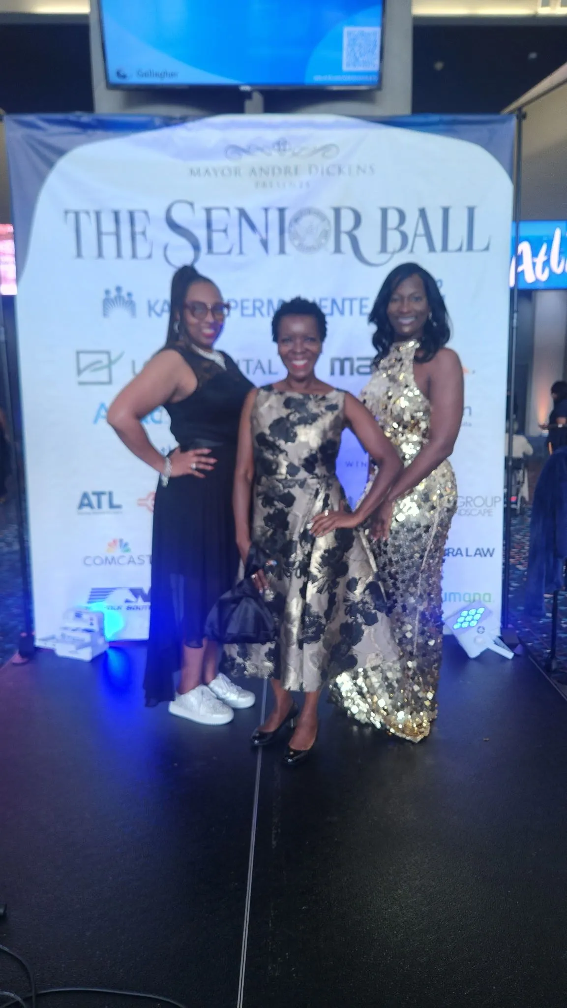Shawn Caprice Houston with two guests in evening wear at The Senior Ball community event