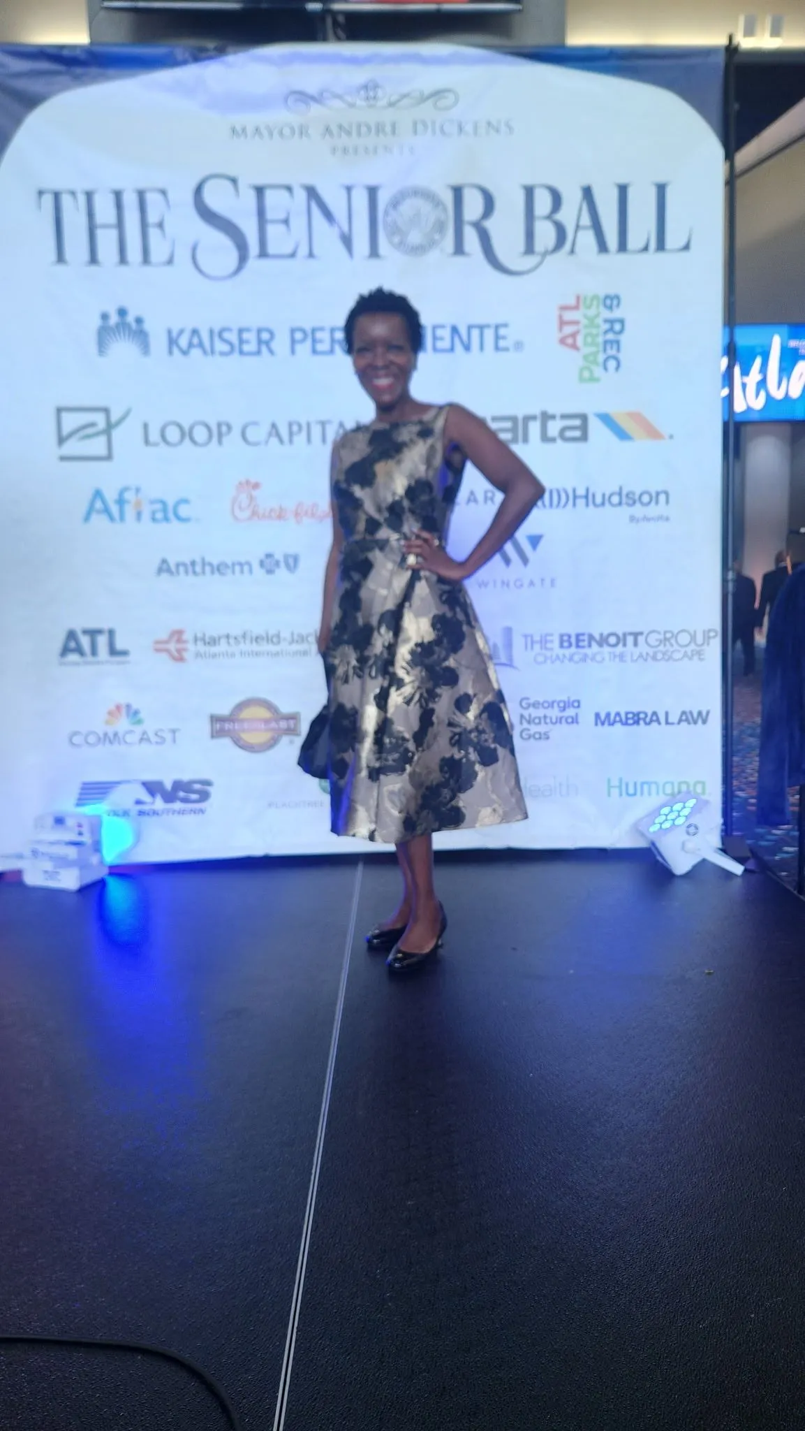 Shawn Caprice Houston in a floral gold-and-black dress at The Senior Ball community event