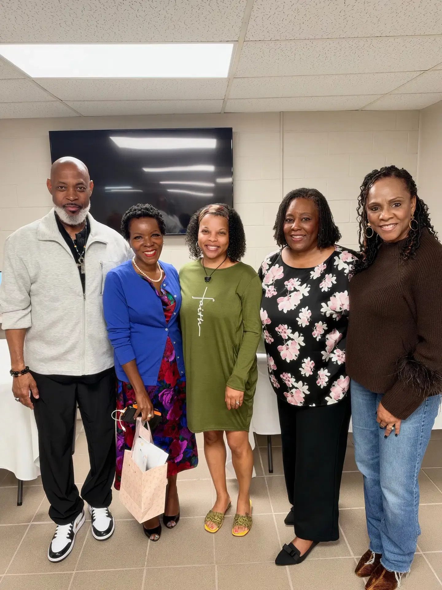 Shawn Caprice Houston with four community members at an indoor gathering