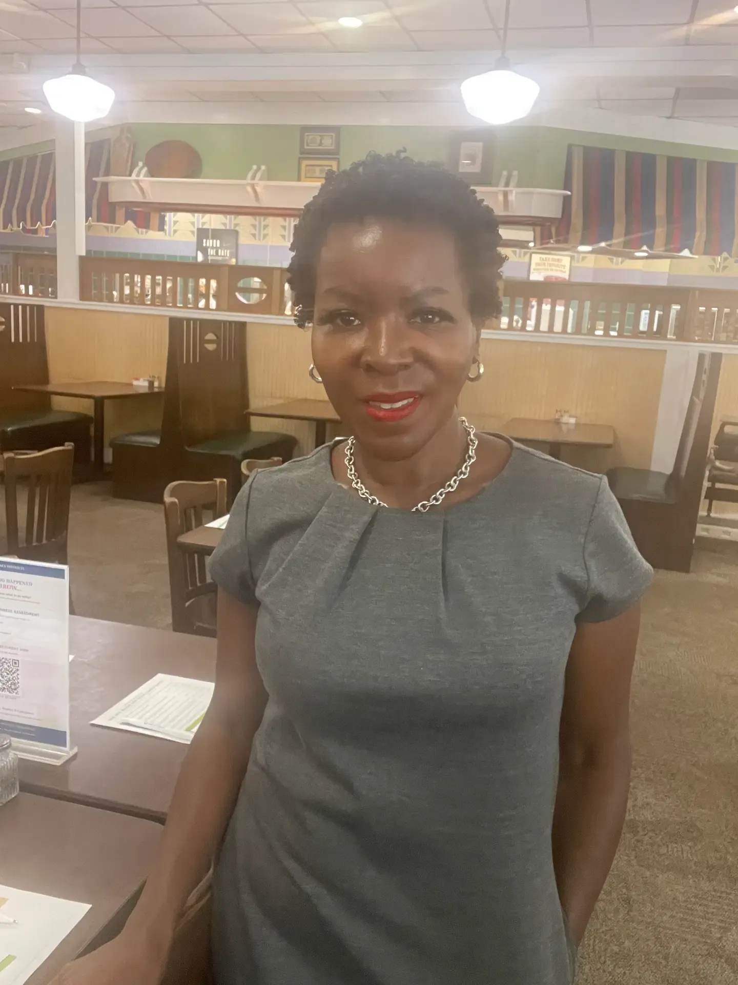 Shawn Caprice Houston speaking with a visitor at a community information table